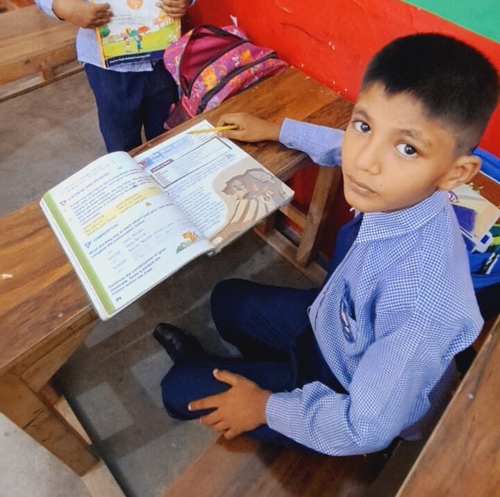 New student desks and books at school in Pakistan